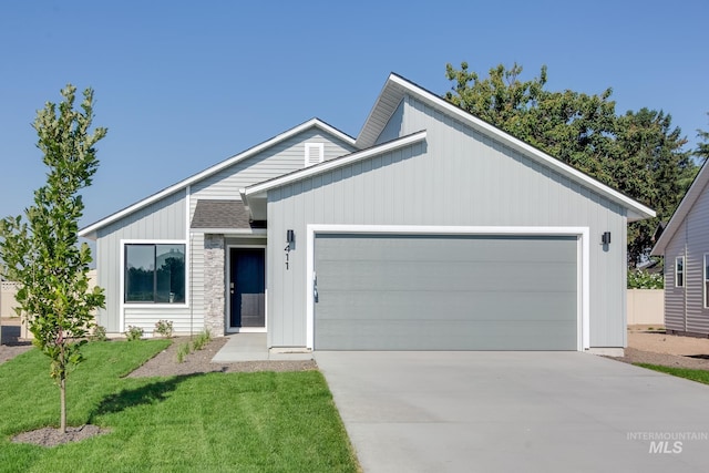 view of front of house with a garage and a front yard