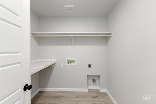 4429 N Magical Creek Ave, Meridian, ID 83646 - laundry room with hookup for an electric dryer, light wood-type flooring, washer hookup, baseboards, and an office area