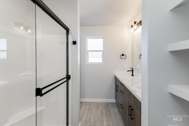 4429 N Magical Creek Ave, Meridian, ID 83646 - full bath with wood finished floors, tiled shower, double vanity, and baseboards