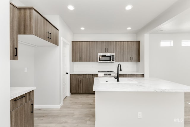 4429 N Magical Creek Ave, Meridian, ID 83646 - kitchen featuring stainless steel microwave, light wood-style flooring, modern cabinets, and recessed lighting