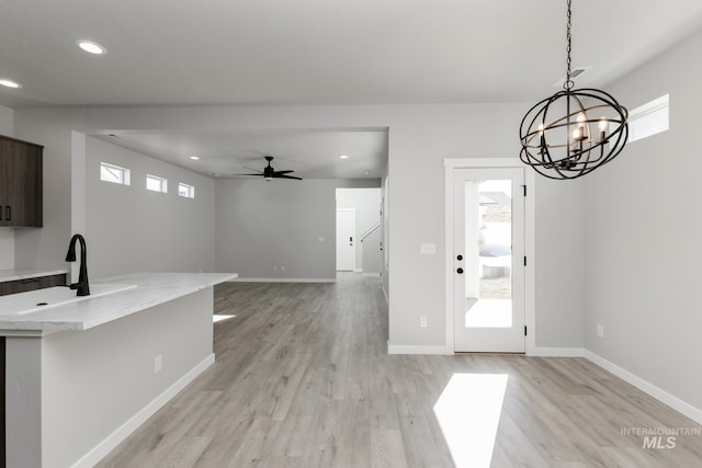 4429 N Magical Creek Ave, Meridian, ID 83646 - unfurnished dining area with healthy amount of natural light, light wood finished floors, recessed lighting, a chandelier, and baseboards