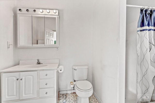 bathroom featuring toilet, a shower with shower curtain, tile patterned flooring, and vanity