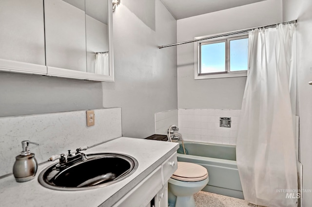 full bathroom featuring toilet, vanity, and shower / bathtub combination with curtain