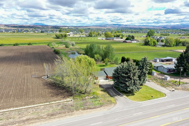 birds eye view of property featuring a mountain view and a rural view