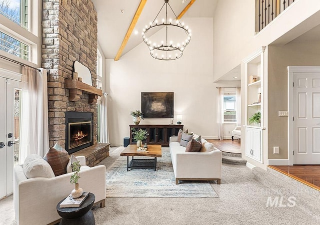 living room with a fireplace, an inviting chandelier, high vaulted ceiling, beamed ceiling, and baseboards