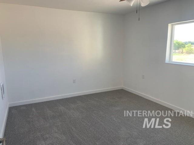 5720 SE 3rd Ave, New Plymouth, ID 83655 - spare room featuring dark colored carpet, a ceiling fan, and baseboards