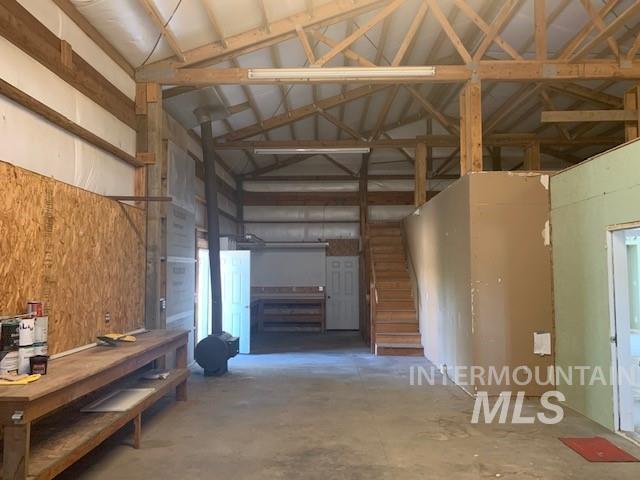 5720 SE 3rd Ave, New Plymouth, ID 83655 - miscellaneous room featuring high vaulted ceiling, concrete floors, and a workshop area