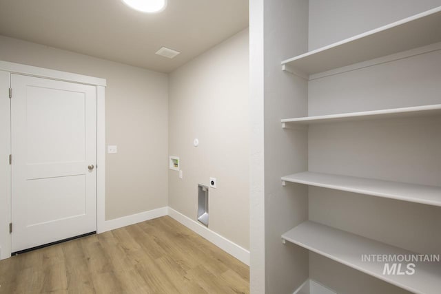 1541 Regency Way, Emmett, ID 83617 - washroom featuring hookup for an electric dryer, light wood finished floors, washer hookup, and baseboards