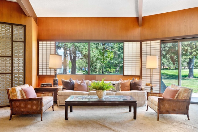 sunroom / solarium with vaulted ceiling with beams and a healthy amount of sunlight