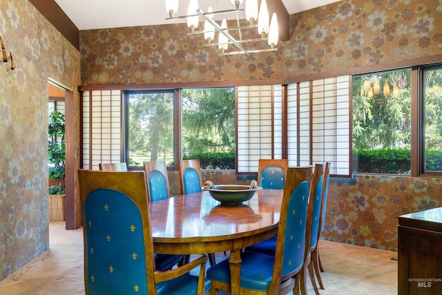 dining area featuring a textured ceiling and a chandelier