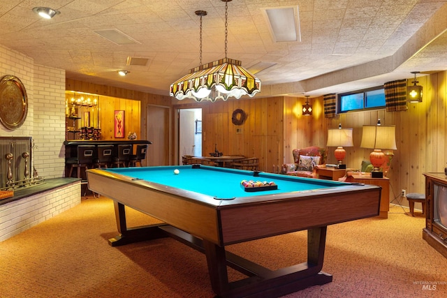 game room featuring wood walls, brick wall, bar area, light colored carpet, and billiards