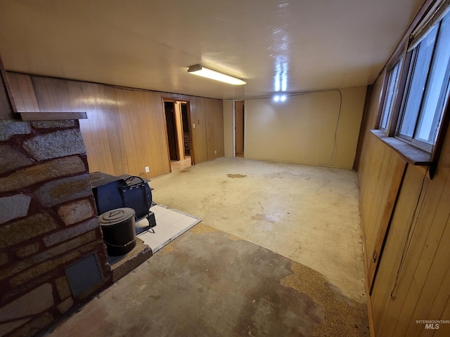 basement featuring wooden walls