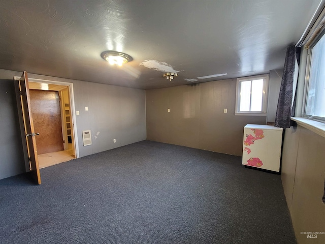 interior space with heating unit and carpet flooring