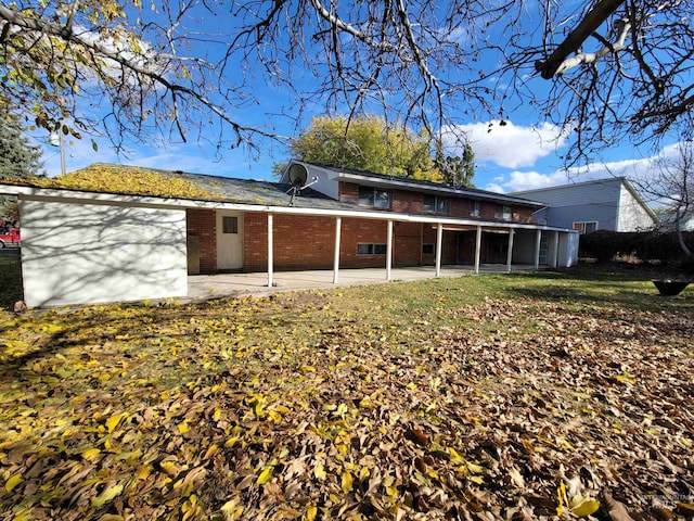 back of property featuring a sunroom and a patio area