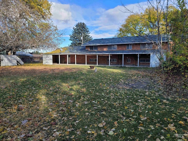 back of house with a lawn