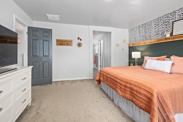 bedroom with visible vents, baseboards, and light carpet