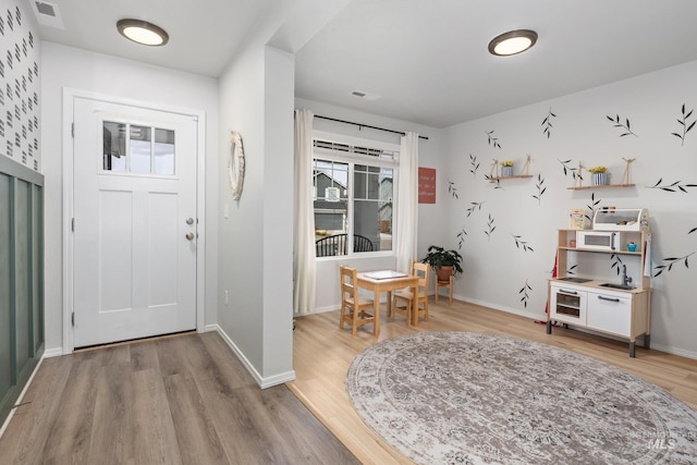 entrance foyer featuring baseboards, visible vents, and light wood finished floors