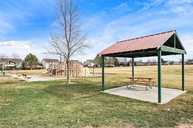 view of home's community with a patio area, a lawn, and playground community