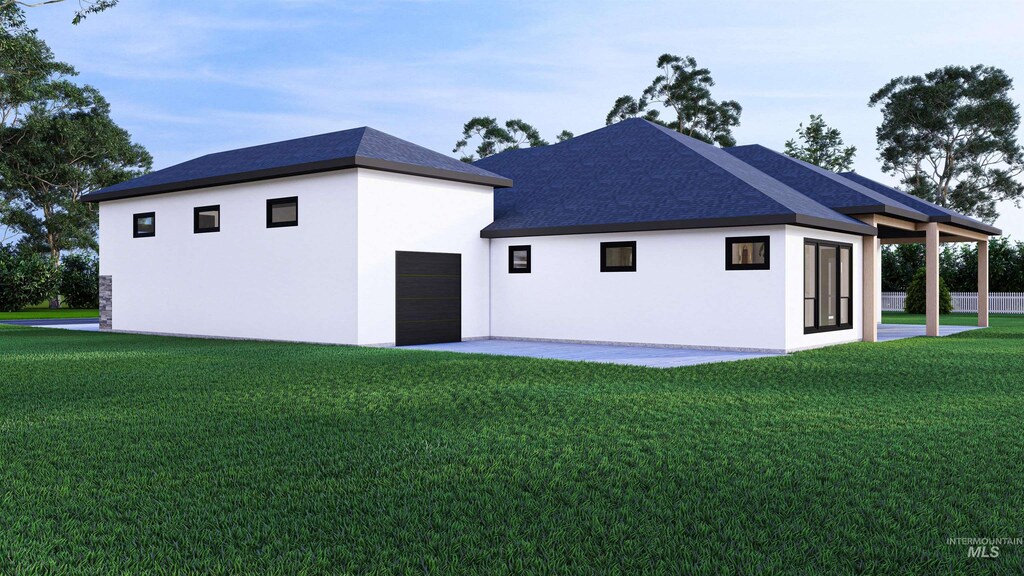 22909 Cirrus Vw, Caldwell, ID 83709 - rear view of house with a yard, stucco siding, and a garage