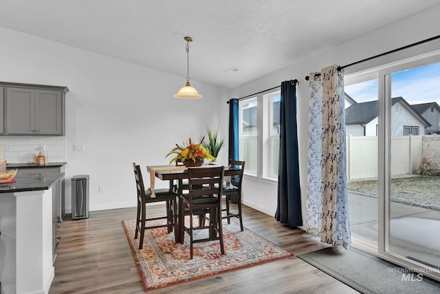 dining room featuring dark wood finished floors and baseboards