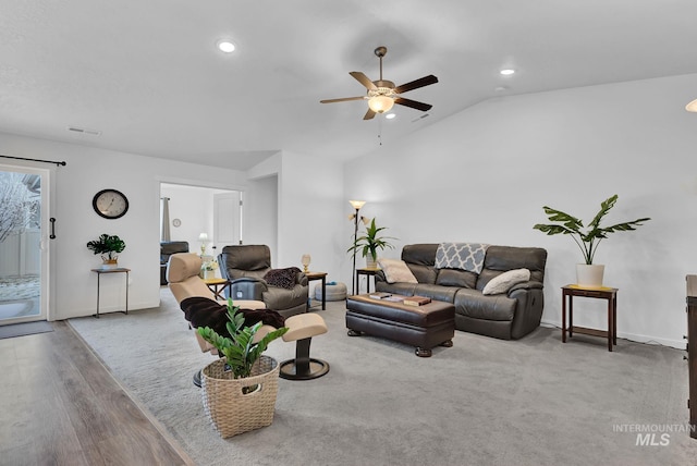 living area featuring visible vents, wood finished floors, recessed lighting, baseboards, and vaulted ceiling