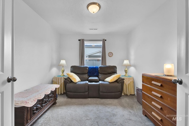 living area with visible vents and carpet flooring