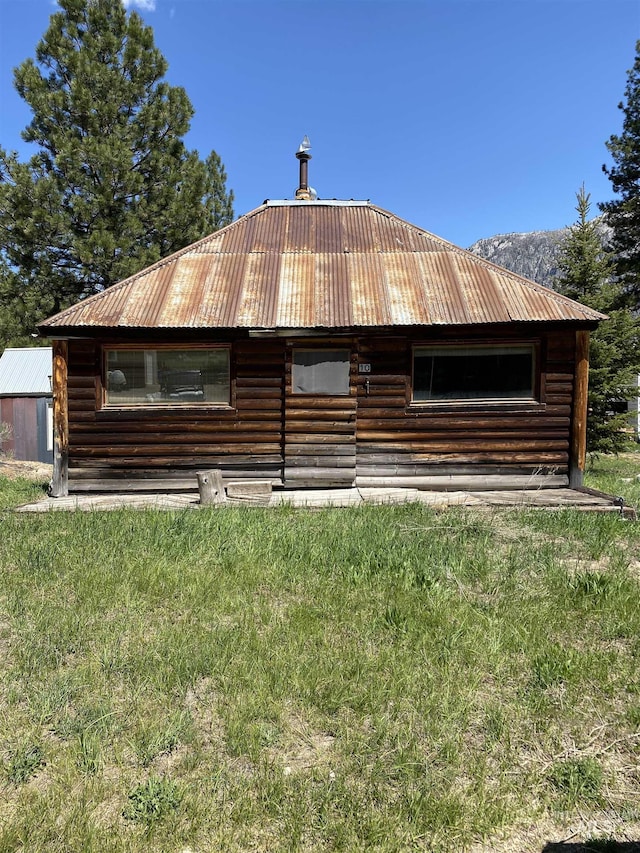 10 E Coffin St, Atlanta, ID 83716 - back of property featuring metal roof and log siding