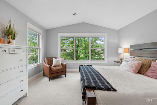 bedroom featuring vaulted ceiling, light colored carpet, and baseboards