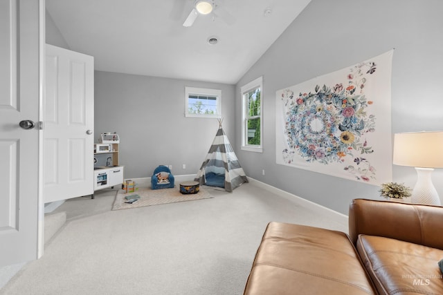 playroom with a ceiling fan, carpet, vaulted ceiling, and baseboards