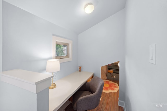 home office featuring vaulted ceiling and wood finished floors