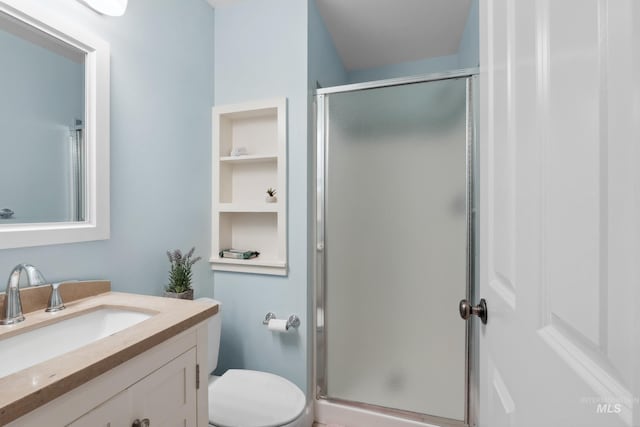 full bathroom with a shower stall, toilet, and vanity