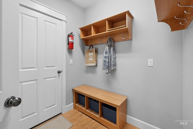 mudroom featuring light wood-style floors and baseboards