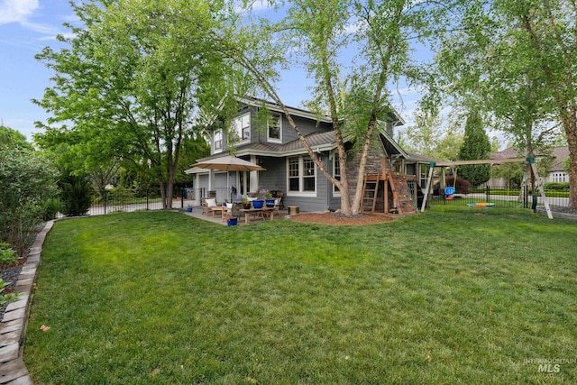 rear view of property featuring a patio, a playground, and a gazebo