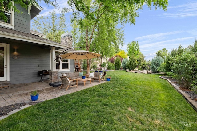 view of grassy yard with a patio and outdoor lounge area