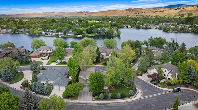 aerial perspective of suburban area featuring a water and mountain view