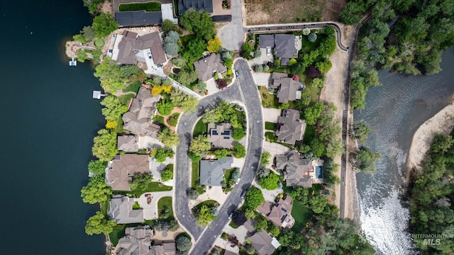 aerial view of property and surrounding area with nearby suburban area and a nearby body of water