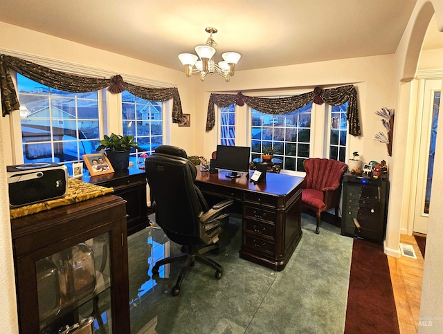 office space with a chandelier and hardwood / wood-style flooring