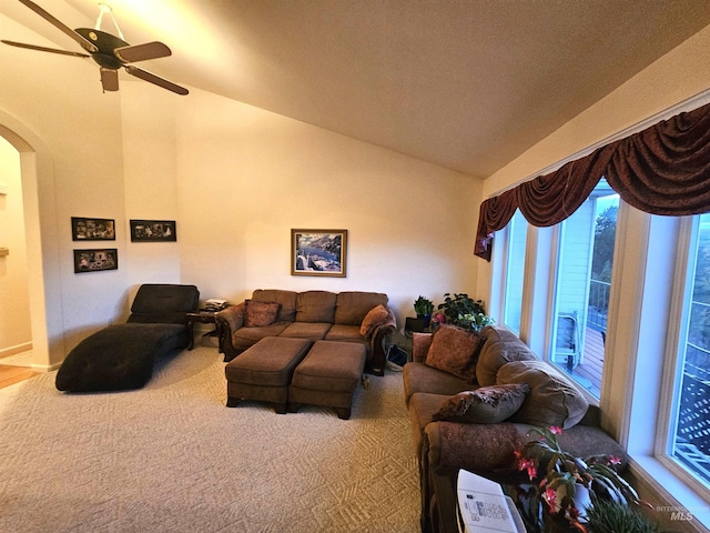 carpeted living room with vaulted ceiling and ceiling fan