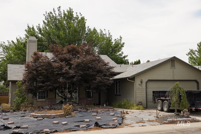 1011 N Spirea, Boise, ID 83713 - view of front of property featuring a garage and a chimney