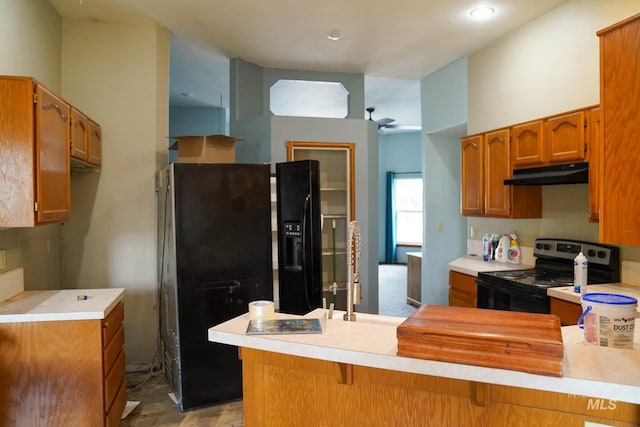 1011 N Spirea, Boise, ID 83713 - kitchen featuring black appliances, under cabinet range hood, a peninsula, light countertops, and brown cabinetry