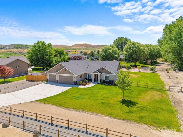 7253 River View Dr, Marsing, ID 83639 - view of front of property featuring concrete driveway, board and batten siding, a garage, and a view of rural / pastoral area