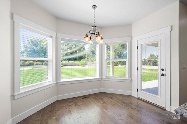 7253 River View Dr, Marsing, ID 83639 - unfurnished dining area with a chandelier, plenty of natural light, and dark wood finished floors