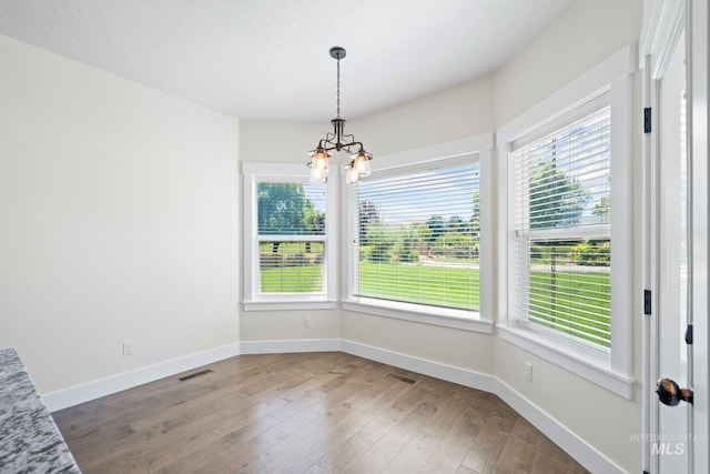 7253 River View Dr, Marsing, ID 83639 - unfurnished dining area featuring a chandelier and hardwood / wood-style floors