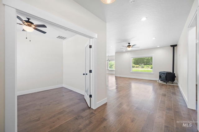 7253 River View Dr, Marsing, ID 83639 - unfurnished room with a ceiling fan, a wood stove, wood finished floors, and recessed lighting