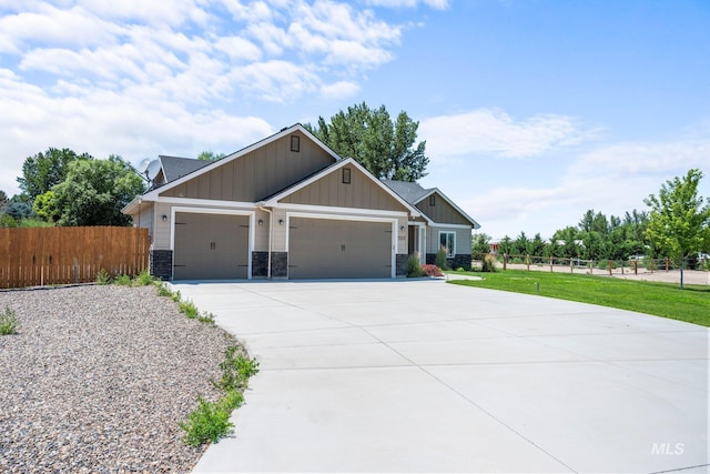 7253 River View Dr, Marsing, ID 83639 - craftsman-style home featuring board and batten siding, a garage, concrete driveway, and stone siding