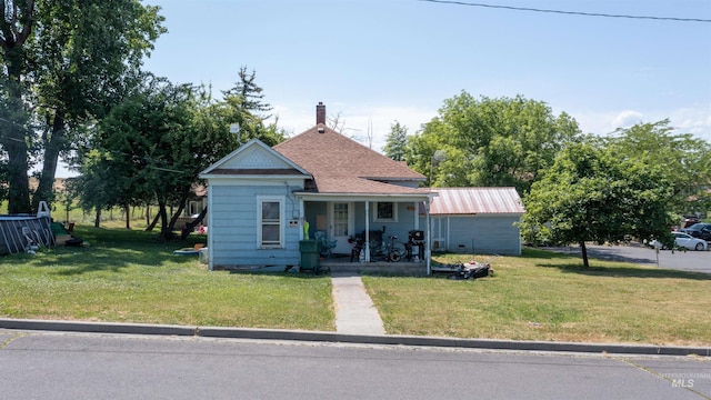 420 S E St, Grangeville, ID 83530 - bungalow-style house featuring covered porch, a front lawn, a chimney, and roof with shingles