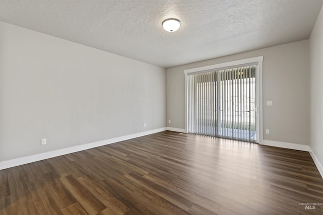 unfurnished room with baseboards, a textured ceiling, and wood finished floors