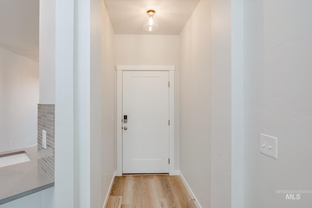 doorway to outside with light wood-style floors