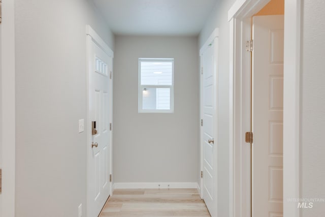 hallway with light hardwood / wood-style floors