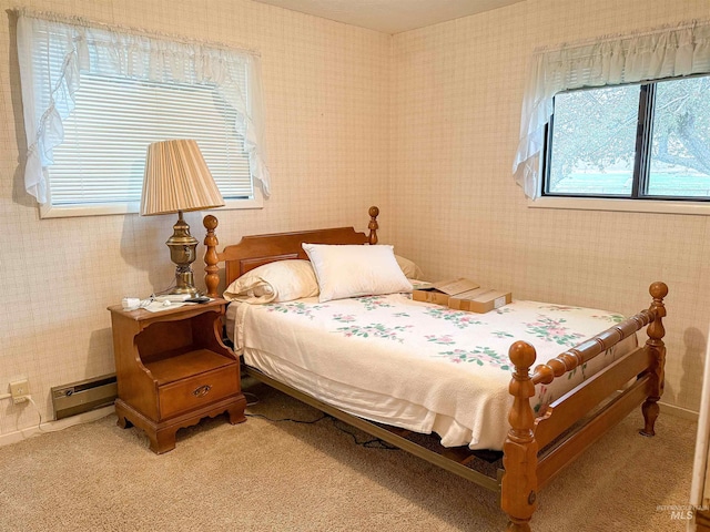 bedroom with wallpapered walls, multiple windows, and baseboard heating